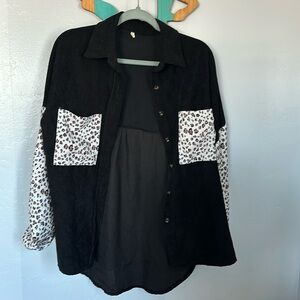 Black corduroy button up jacket with cheetah sleeves and pockets on each side